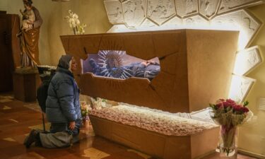 A nun prays at the tomb of Carlo Acutis in the Church of Santa Maria Maggiore in Assisi