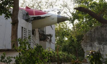 A firefighter works at the site where Air India flight 171 crashed in a residential area near the airport in Ahmedabad on June 12