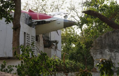 A firefighter works at the site where Air India flight 171 crashed in a residential area near the airport in Ahmedabad on June 12