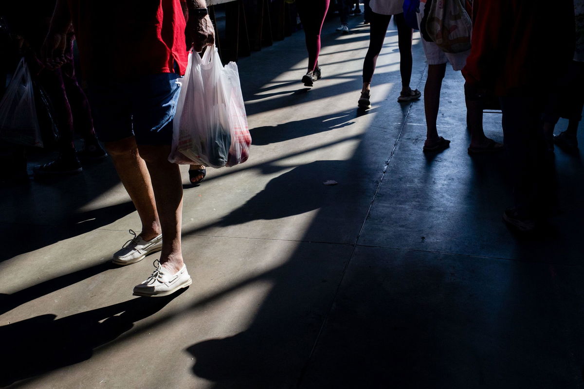<i>Emily Elconin/Bloomberg/Getty Images via CNN Newsource</i><br/>A shopper carries a bag at a market in Detroit