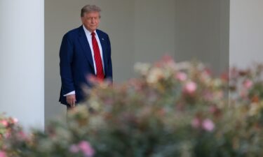 President Donald Trump walks out of the Oval Office and views the Rose Garden construction before boarding Marine One on the South Lawn of the White House on Friday