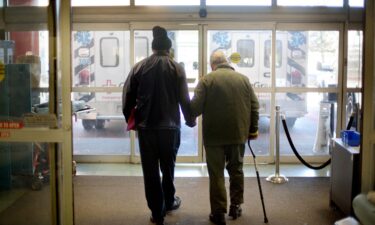 A patient is assisted out of the emergency department at a hospital in Atlanta.