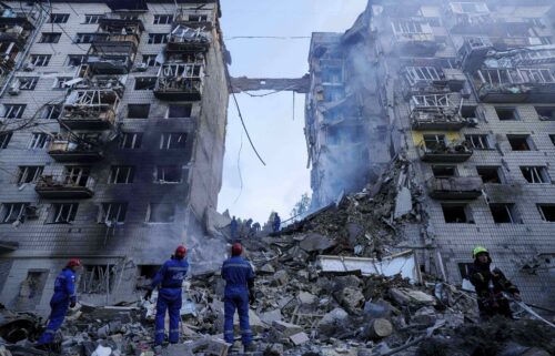 Rescue workers clear the rubble of a multi-storey residential house destroyed by a Russian strike in Kyiv