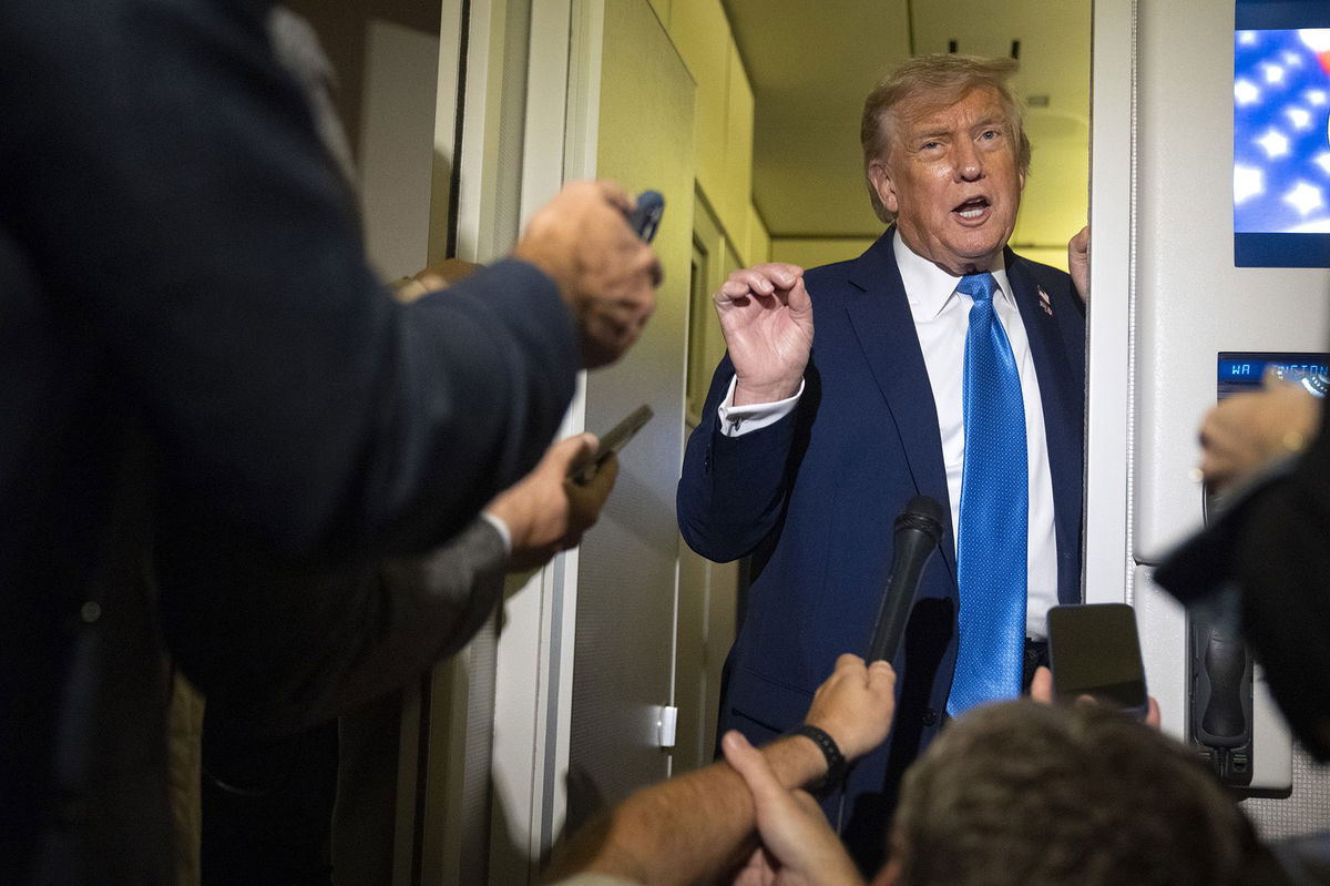 <i>Mark Schiefelbein/AP via CNN Newsource</i><br/>President Donald Trump speaks with reporters while flying aboard Air Force One en route from Calgary