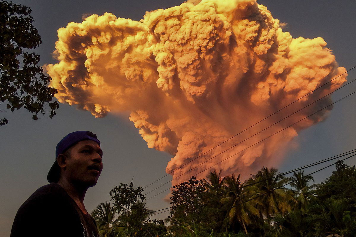 <i>Stringer/AFP/Getty Images via CNN Newsource</i><br/>A villager watches the eruption of Mount Lewotobi Laki-Laki as seen from Talibura village in Sikka