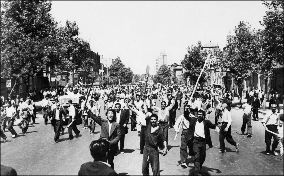 <i>Intercontinentale/AFP/Getty Images via CNN Newsource</i><br/>Pro-monarchy rioters take to the streets of Tehran in August 1953.