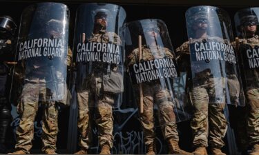 National Guardsmen stand outside of the Edward Roybal Federal Building in downtown Los Angeles