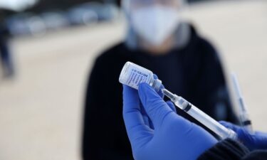 A healthcare worker prepares flu shots during a drive-thru clinic at the Louisiana State Fairgrounds in Shreveport