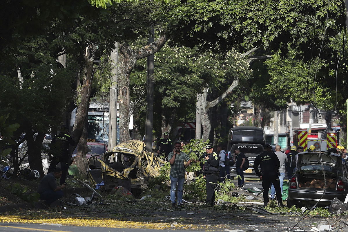 <i>Santiago Saldarriaga/AP via CNN Newsource</i><br/>Security forces inspect the site of a bomb explosion outside an air base in Cali