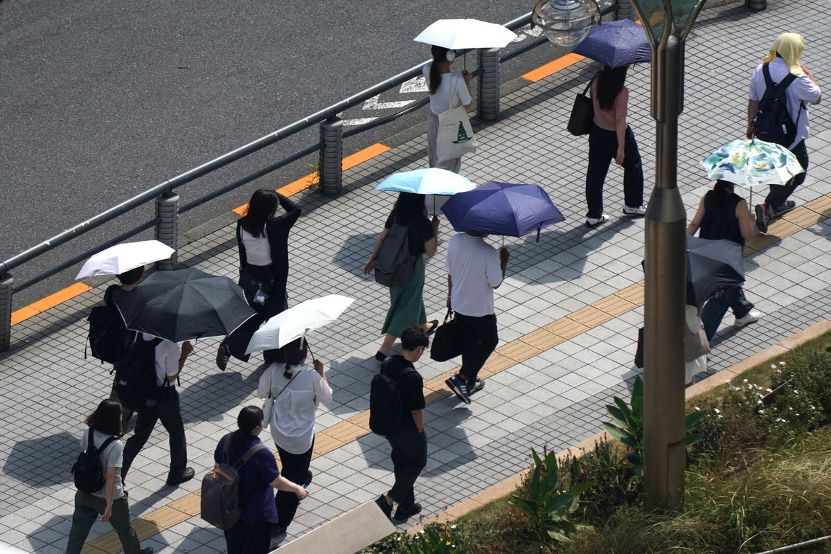 <i>Yuichi Yamazaki/AFP/Getty Images via CNN Newsource</i><br/>People walk underneath a water misting system to cool down on a hot day in Tokyo