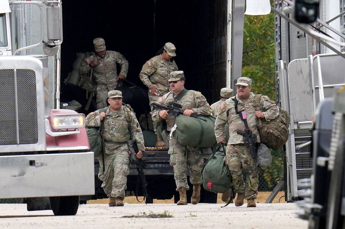 <i>Erin Hooley/AP via CNN Newsource</i><br/>Military personnel in uniforms with the Texas National Guard patch are seen at the US Army Reserve Center in Elwood