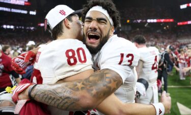 Indiana Hoosiers wide receiver Elijah Sarratt (No. 13) and wide receiver Charlie Becker (No. 80) celebrate after defeating the Ohio State Buckeyes in the 2025 Big Ten championship.