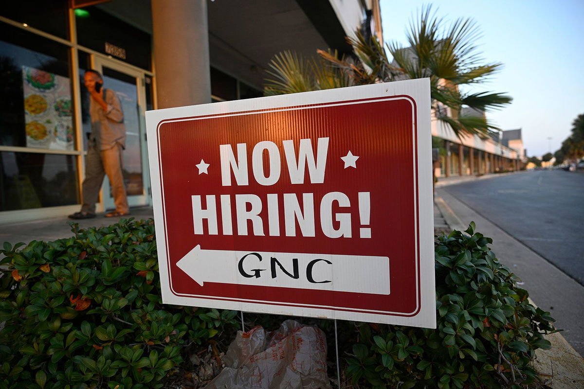 <i>Phelan M. Ebenhack/AP/File via CNN Newsource</i><br/>A "Now Hiring" sign outside a GNC nutritional supplements store on November 23 in Orlando.