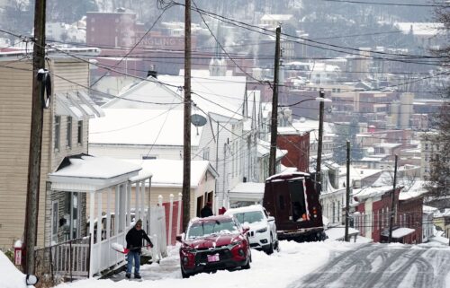 A person shovels a sidewalk after a winter snow storm in Pottsville