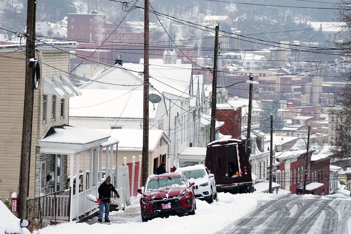 <i>Matt Rourke/AP via CNN Newsource</i><br/>A person shovels a sidewalk after a winter snow storm in Pottsville