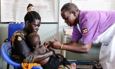 A child waits as a nurse prepares a dose of measles vaccine at a hospital in the Moroccan coastal city of Temara in February 2025. Measles and meningitis infections killed at least 100