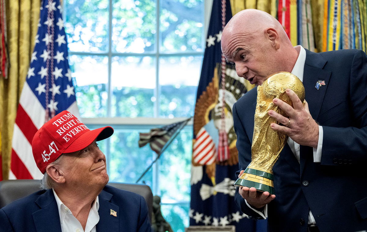 <i>Andrew Caballero-Reynolds/AFP/Getty Images via CNN Newsource</i><br/>Infantino hands the Jules Rimet trophy to Donald Trump in the Oval Office on August 22.